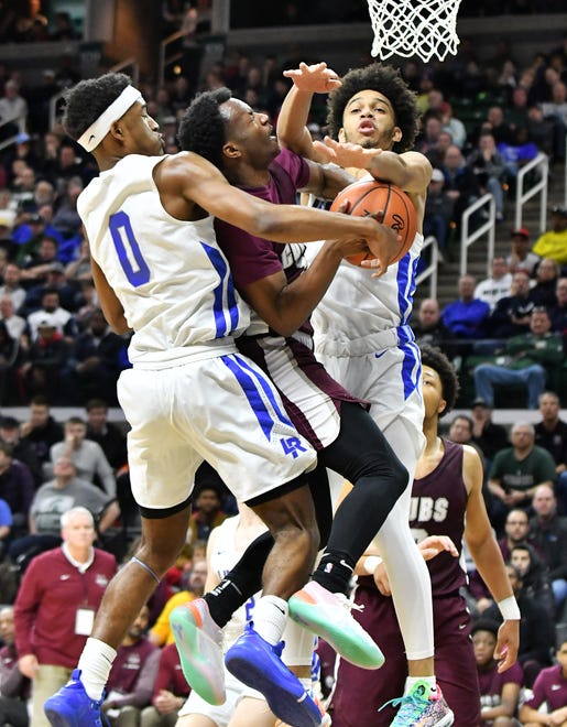 Lincoln guard Tahj Chatman (0) and Lincoln guard Amari Frye (4) converge on U-D Jesuit's Julian Dozier (1) in the second half.