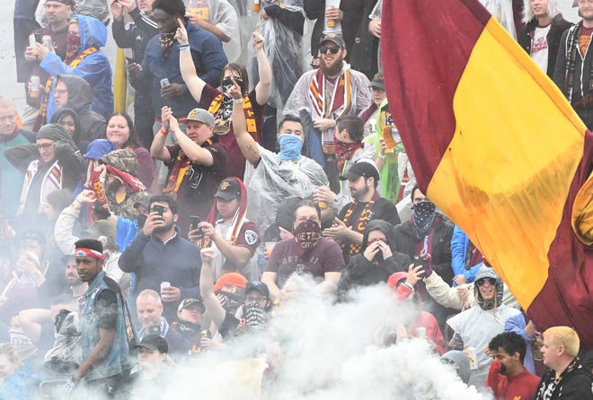 DCFC fans celebrate a goal with smoke bombs after a Detroit goal in the first half of a 2019 match.