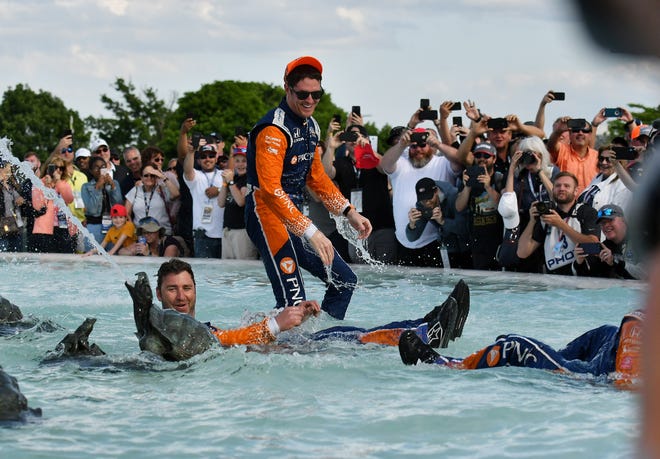 Car 9 driver Scott Dixon, top, of Chip Ganassi Racing gets cooled off and is joined by crew members in the James Scott Memorial Fountain after winning the Dual II IndyCar Series Race at the Chevrolet Detroit Belle Isle Grand Prix on Belle Isle in Detroit on June 2, 2019.  
(Robin Buckson / The Detroit News)