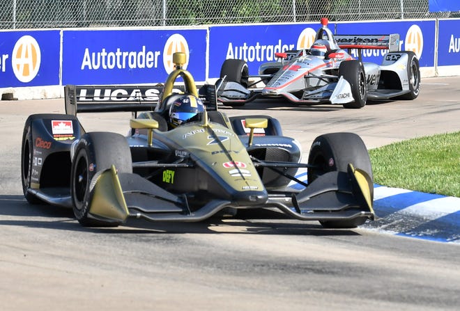 Marcus Ericsson, second place finisher, drives in front of Will Power, third place finisher, in the Dual II IndyCar Series Race at the Chevrolet Detroit Belle Isle Grand Prix on Belle Isle.