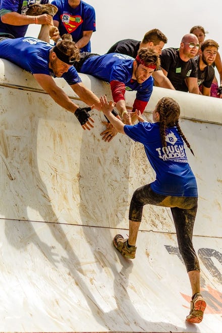 Ellie Giordano, 14, gets a little help from teammates Kaleb Weaver and Ben Peterson to reach the top of the 13-foot sloped wall at the 2018 Tough Mudder event in Oxford. Mom Erica Giordano calls her photo "Teamwork." "We had heard that Tough Mudder is all about team spirit and the ability to conquer challenges with the help of friends, and wanted to give it a shot," she said. "What a rush!"