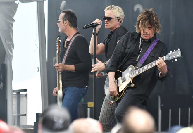 From left, Bassist Robert DeLeo, lead vocalist Jeff Gutt and guitarist Dean DeLeo of the Stone Temple Pilots perform on the Entertainment Stage at the Chevrolet Detroit Belle Isle Grand Prix on Belle Isle.
