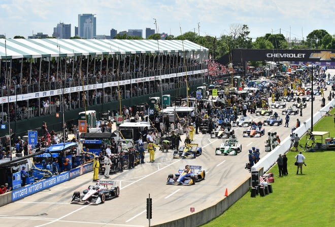 Drivers pull out of the pits for the start of the Dual II IndyCar Series Race at the Chevrolet Detroit Belle Isle Grand Prix on Belle Isle.