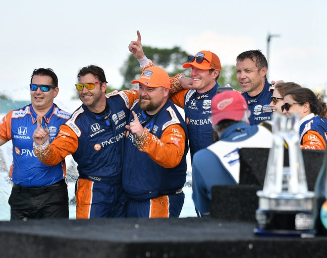 Scott Dixon and his crew pose for a group photo in the James Scott Memorial Fountain after winning the Dual II IndyCar Series Race at the Chevrolet Detroit Belle Isle Grand Prix on Belle Isle.