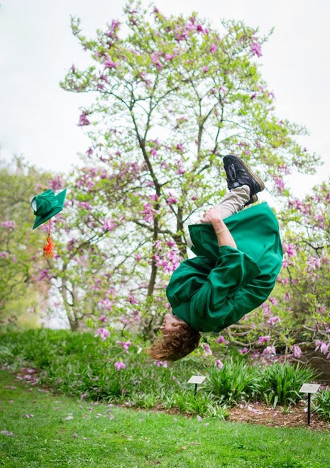 People and Places People ' s Choice Award: " Graduate in Full Bloom, " by Camille Biggs of East Lansing. Michigan State computer engineering graduate Frankie Riviera does a celebratory backflip outside of the library on campus. " The photo really depicts the excitement and fervor of the graduation season, " she said, " and captures the personality of the graduate.