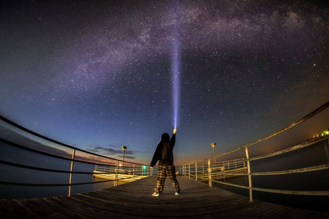 Award of Excellence: " Selfie with the Stars, " by Chase Gagnon of Madison Heights. " Walking out into the darkness and seeing the Milky Way arcing over the pier was such an amazing and memorable experience, " he said of his 2 a.m. shoot on the Harbor Beach pier. A fisheye lens, a flashlight and a steady hand for a 30-second exposure did the trick.