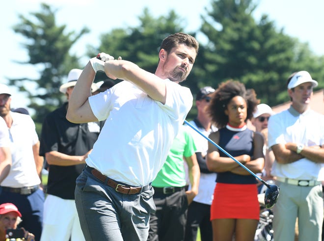 Red Wings star Dylan Larkin drives off the 15th tee.