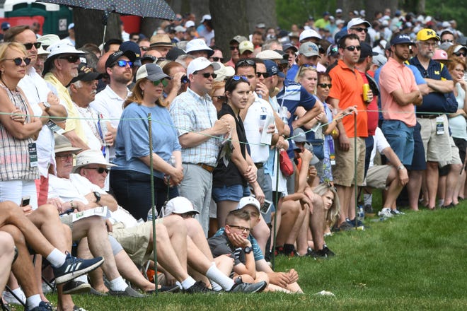 Fans line the fairway on 9.