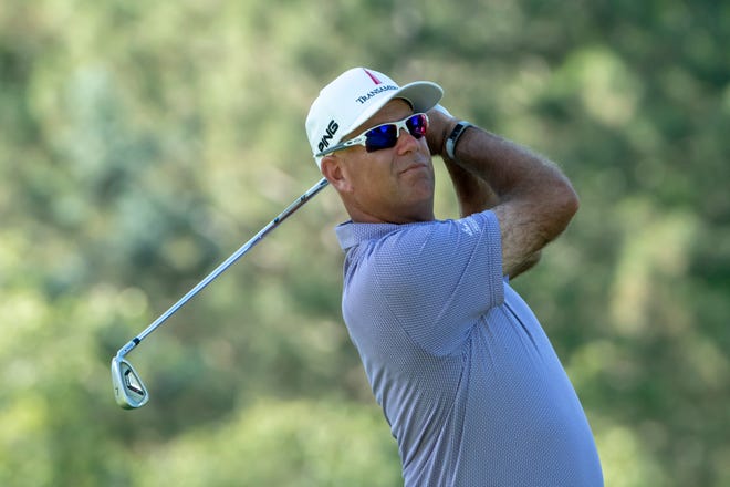 Stewart Cink tees off on the ninth hole.  Cink shot a 65 for the day.