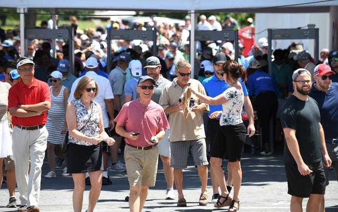 Spectators enter and go through security at the Rocket Mortgage Classic.