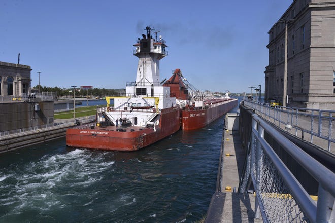The Great Lakes Trader and the tug Joyce L. VanEnkevort exits the Poe Lock at the Soo Locks in Sault Ste. Marie.
