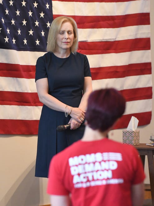 Democratic presidential candidate Sen. Kirsten Gillibrand listens and then replies to a woman who says she has experienced gun violence, at a stop of the 'Trump Broken Promises Tour.'