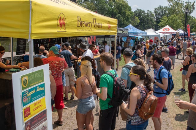 Beer drinkers line up at the tent of Grand Rapids' Brewery Vivant at the Michigan Brewers Guild 2019 Summer Beer Festival Saturday. Brewery Vivant is known for making Belgian-styled ales.