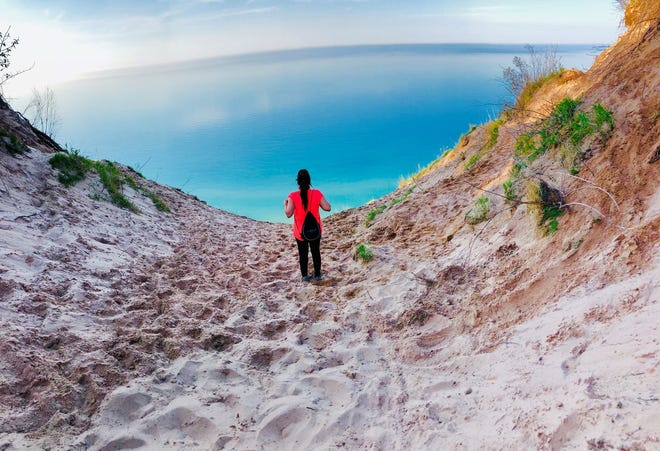 " Seas the Day, " by Nisha Dubey of Rochester Hills. The Log Slide Overlook at Pictured Rocks National Lakeshore is a frequently photographed scene, but Dubey figured out a way to make it her own. " I tucked my phone on the sand, set it on 10 seconds self-timer mode and ran as far as I could towards the water. Finally, after 10 seconds I got the shot I wanted.