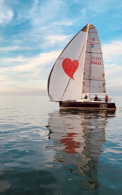 " Love on the Lake, " by Margarida Bernardo of Grosse Pointe. Her photography gear was at home, but when she saw this love boat at the end of a procession on Lake St. Clair, " The excitement of the regatta, the sunset and the beautiful reflections on a mirror-like lake were too much to miss, so I grabbed my iPhone and started shooting.