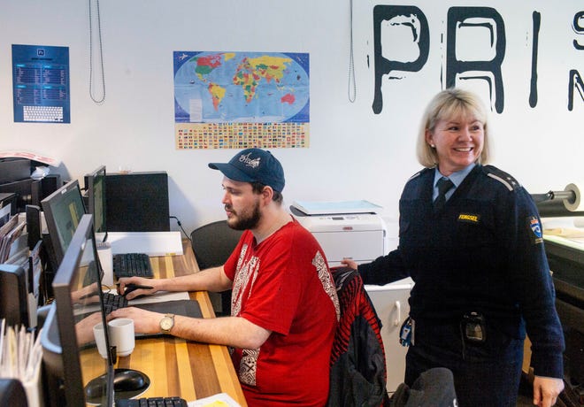 Inmate Fredrik Soerfjordmo designs artwork on a computer, watched by Works Manager Janne Hasle, in the digital print shop at Halden Prison in Norway. Staff at Halden are not armed. Instead, they practice "dynamic security," a disciplinary system based on relationship-building, communication and mutual trust.