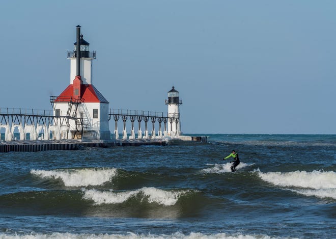 " Winter Surfing, " by Linda Urban of Sterling Heights. On a February vacation, she stopped at the St. Joseph lighthouse in hopes of photographing ice formations. Instead, " There was no ice on the lighthouse but there were three men surfing in waves that were filled with pancake ice. It was 31 degrees with a wind chill that was bone-chilling.