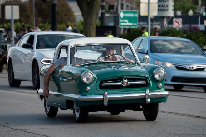 A tiny Nash Metropolitan makes its way down Woodward  near Nine Mile in Ferndale, during the Woodward Dream Cruise.