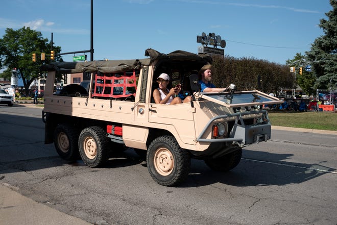 A customized military vehicle makes its way down Woodward Avenue near Nine Mile in Ferndale.