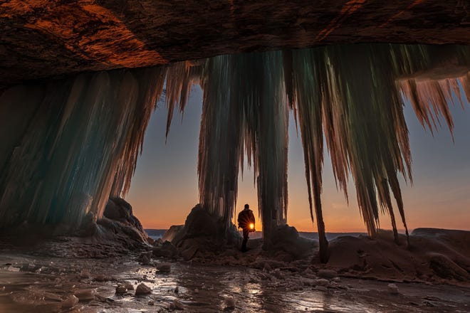 Four-Season Fun People ' s Choice Award: " Better Than Coffee, " by Thomas Bos of White Lake, taken at sunrise at an ice cave at Grand Island National Recreation Area. " The silence was loud that morning, " he said, " with the cracking and popping of the ice, water dribbling down the stalactites, a few birds chirping, a light wind periodically whistling, and the crunch of the ice under my feet as I set up my camera.
