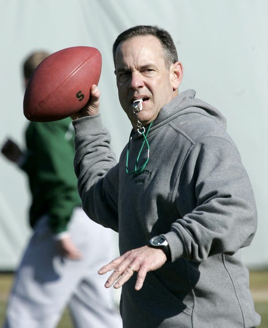 MSU's new head coach Mark Dantonio helps run his players through drills during the first practice of the season at the Michigan State University football practice at their outdoor practice facility on March 20, 2007, in East Lansing.