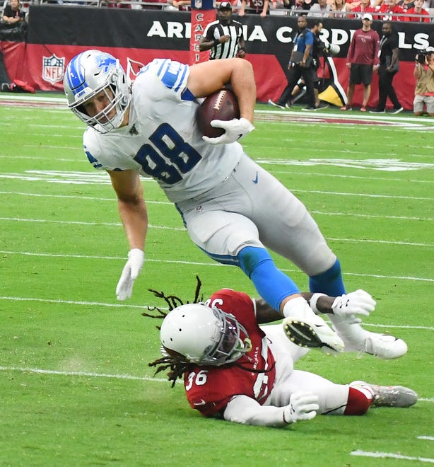 Lions' T.J. Hockenson is upended by Cardinals' D.J. Swearinger Sr. after a long run in the second quarter.