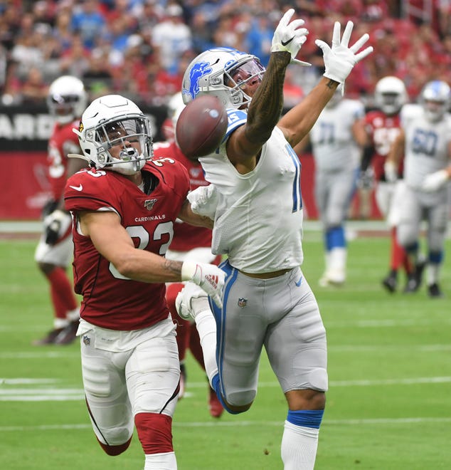 Lions' Marvin Jones Jr. can't pull in a reception with Cardinals' Byron Murphy defending late in the second quarter.