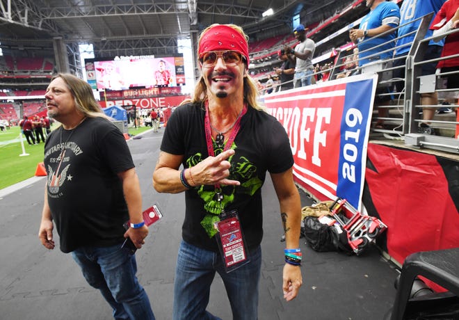 Singer Bret Michaels with the group Poison visits the sideline in Phoenix, signing autographs and visiting with Detroit Lions head coach Matt Patricia before the game.