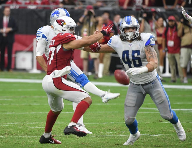 Lions ' Sam Martin ' s punt is blocked by Cardinals ' D.J. Foster, which gave Arizona good field position on Cardinals ' offensive drive which ended up tying the game and sending it into overtime late in the fourth quarter.