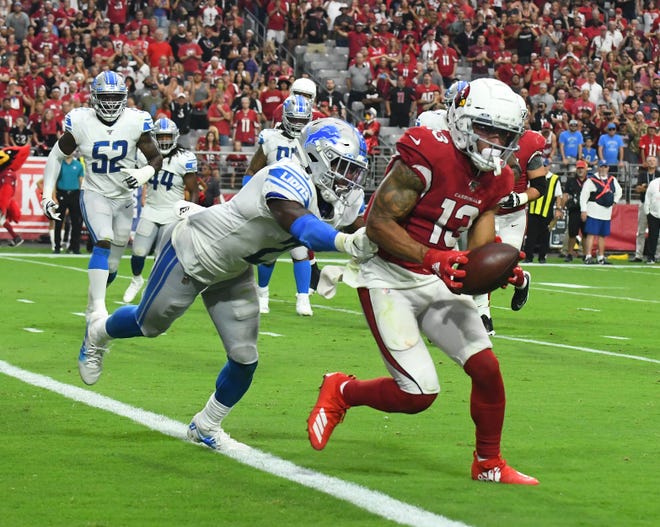 Cardinals ' Christian Kirk runs in the 2-point conversion in front of Lions ' Tracy Walker to tie the game 24-24 at the end of the fourth quarter.