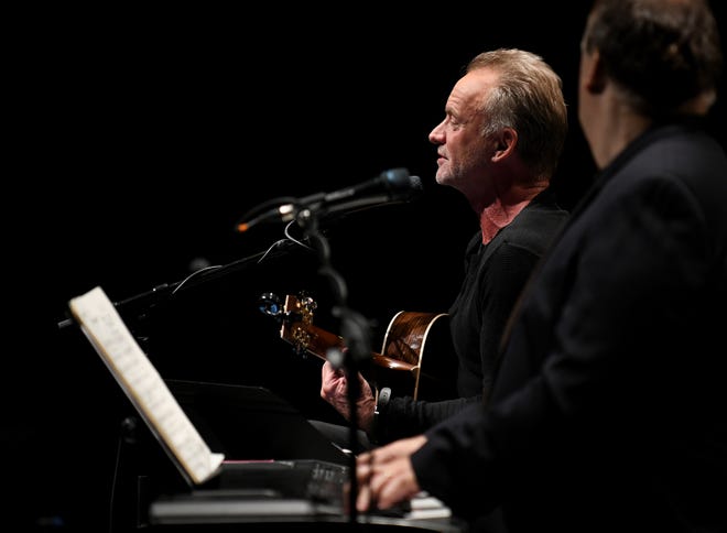 British musician Sting performs a private concert with keyboardist Rob Mathes, right, playing some of the songs from his musical.