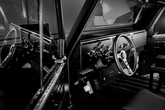 The dashboard and doors of the Bollinger vehicles show flat, hard surfaces.