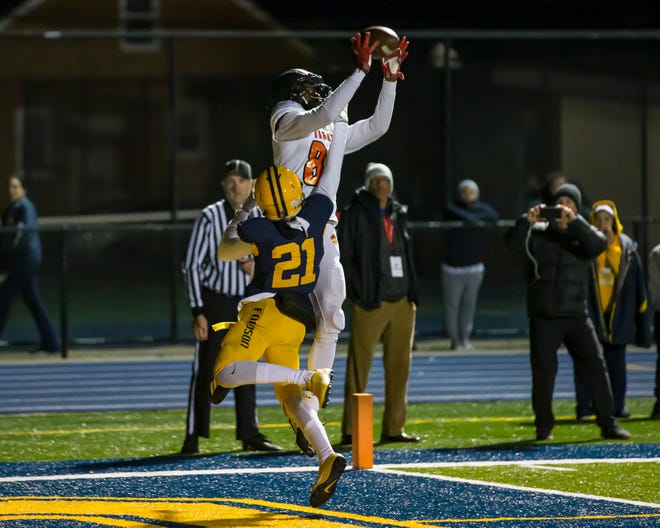 Belleville ' s Connor Bush (82) leaps over Fordson ' s Branden Thomas (21) and catches the winning touchdown late in the fourth quarter.