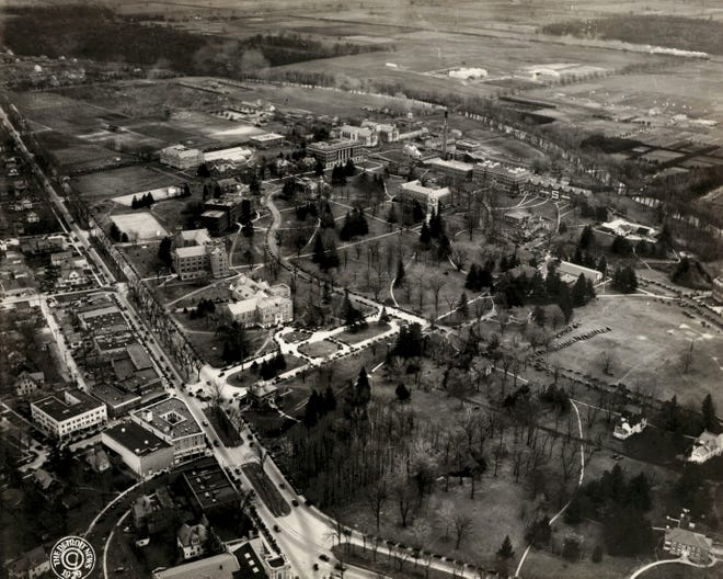 The building left of center with the boulevard in front is the MAC Memorial Union at Michigan State, which has been the center of campus life since it opened in 1925.  It was renamed the MSU Union in 1955.  Grand River Avenue is at left.  The Red Cedar River skirts around the campus at upper right.