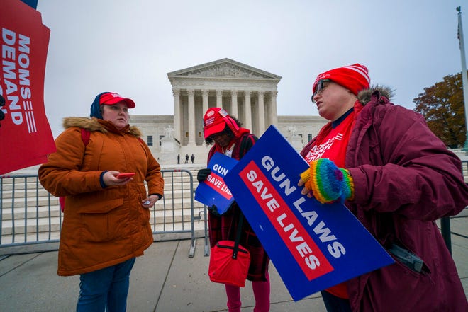 Activists gather outside the Supreme Court before the justices hear arguments in a case brought by gun owners in New York City, on Capitol Hill in Washington, Monday, Dec. 2, 2019. Advocates of gun control worry that the court's conservative majority could use the case to call into question restrictions across the country.