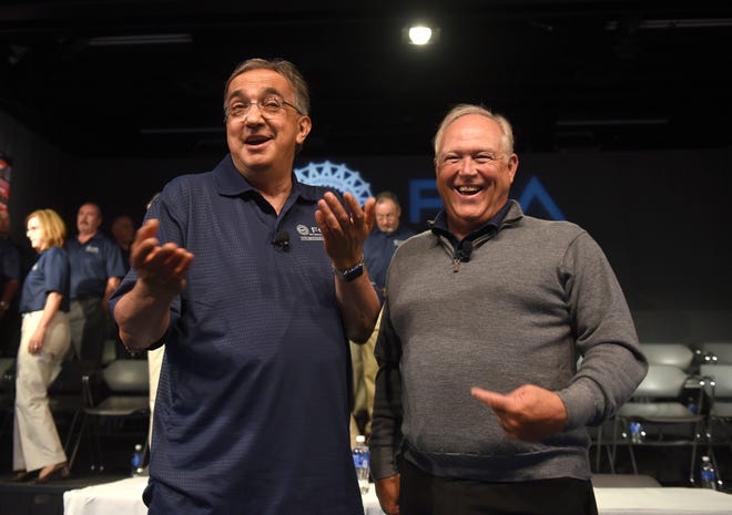 Fiat Chrysler CEO Sergio Marchionne, left, and UAW President Dennis Williams joke around as they answer questions on the first day of contract negotiations between the UAW and FCA in Detroit on  July 14, 2015.