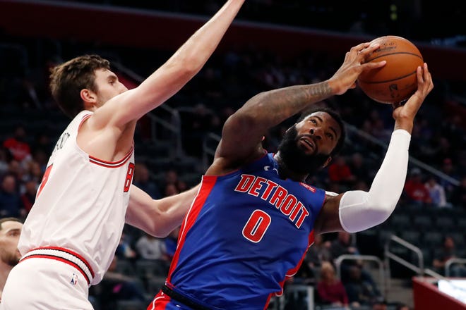 Chicago Bulls forward Luke Kornet, left, defends as Detroit Pistons center Andre Drummond (0) attempts to shoot during the first half.