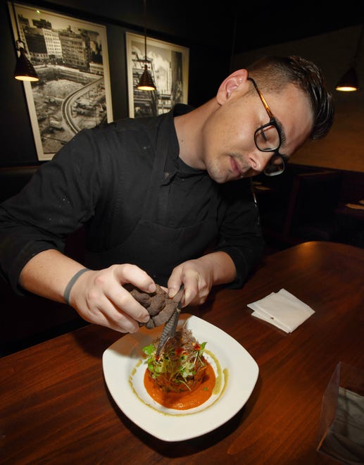 Savant owner, chef Jordan Whitmore shaves black truffle on top of the Ratatouille Confit Byaldi.