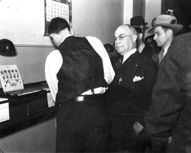 Detroit Mayor Richard W. Reading is fingerprinted in April, 1940. He would be was sentenced to 4½ to 5 years for graft, selling protection to numbers' racketeers and promotions to police officers. Dozens of others were sent to prison including Sheriff Thomas Wilcox and Prosecutor Duncan McCrea. It was the largest political scandal in the city's history.