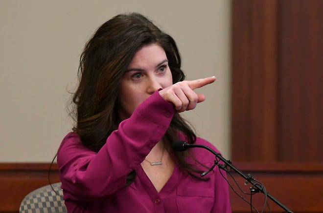 Larissa Boyce, a former patient of Larry Nassar and youth gymnast under Kathie Klages, points out Klages in the courtroom during in the opening day in Klages trial in Ingham County Circuit Court in Lansing, February 11, 2020. Klages, a former Michigan State University gymnastics coach, is accused of lying to police about what she knew about the crimes of sex abuser Larry Nassar.