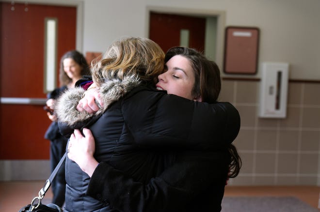 Former youth gymnast Larissa Boyce, right is hugged outside the courtroom after Boyce testified in Ingham County Circuit Court in the trial of MSU Gymnastics coach Kathie Klages, February 11, 2020.  Klages is charged with lying to investigators and denies being told by young gymnasts about sexual abuse by Larry Nassar.