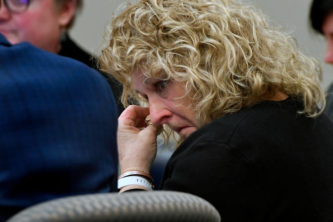 Former MSU Gymnastics coach Kathie Klages wipes away tears with a tissue in Ingham County Circuit Court, February 11, 2020, as she listens to a recording of a police investigator interview with her played back as evidence. In the recording Klages denied being told by young gymnasts about sexual abuse by Larry Nassar.
