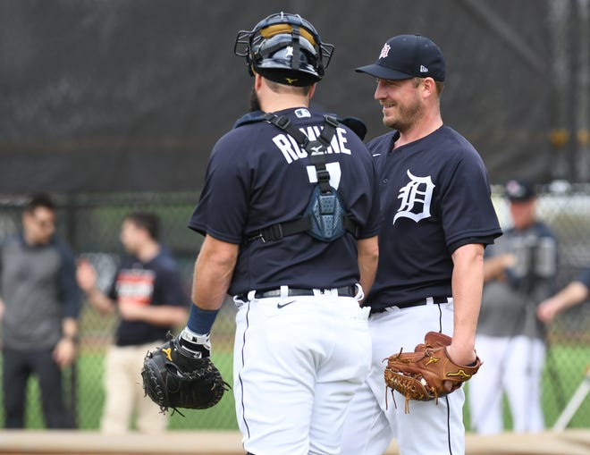 Tigers pitcher Jordan Zimmermann talks with catcher Austin Romine after their bullpen session.