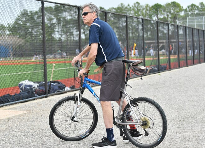 Entering his 42nd season with the Tigers, clubhouse manager Jim Schmakel pauses to talk with some folks while on his usual mode of transportation at spring training, his trusty bike.