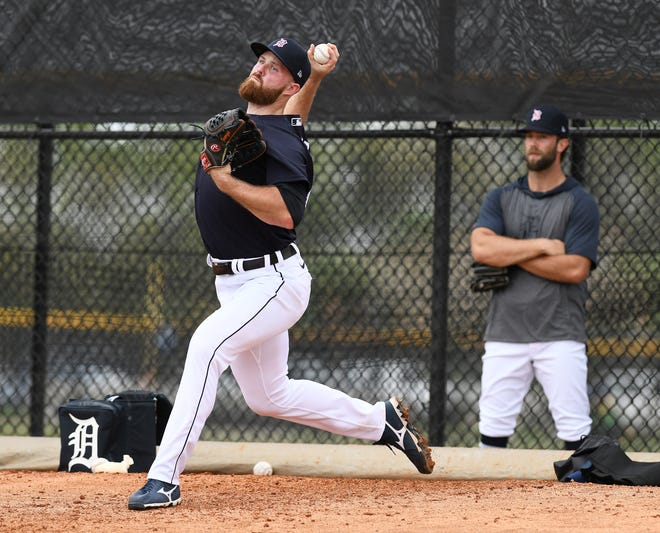 Tigers pitcher Daniel Norris, right, watches while Buck Farmer works in the bullpen.