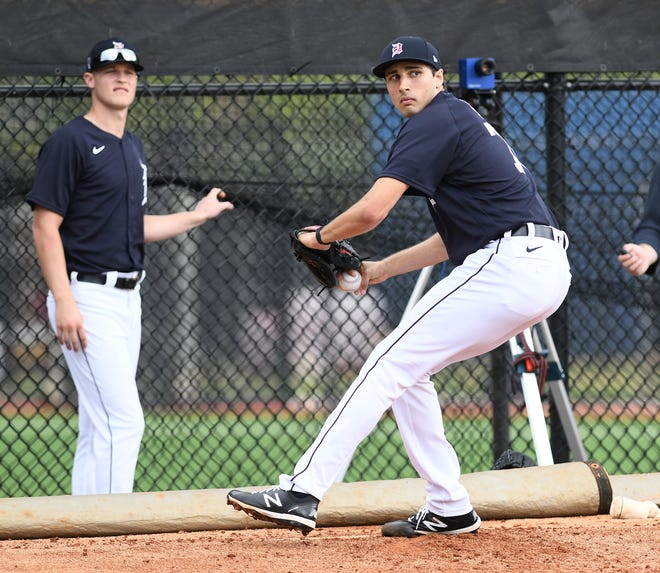 Tigers pitcher Matt Manning, left, watches while Alex Faedo works in the bullpen.