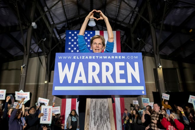 Presidential candidate Senator Elizabeth Warren sends some love to the audience after speaking during a campaign stop inside Shed 5 at Eastern Market, in Detroit, March 3, 2020.
