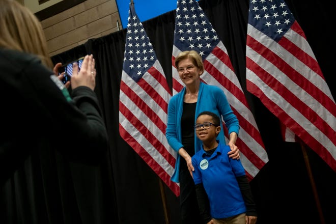Presidential candidate Senator Elizabeth Warren poses for a photo with six-year-old Zachary Taylor, of Novi, before speaking during a campaign stop inside Shed 5 at Eastern Market, in Detroit, March 3, 2020.