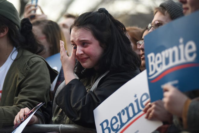 A supporter of U.S. Senator and presidential candidate Bernie Sanders weeps as he addresses the crowd on the campus of The University of Michigan, Sunday, March 8, 2020 in Ann Arbor, Mich.