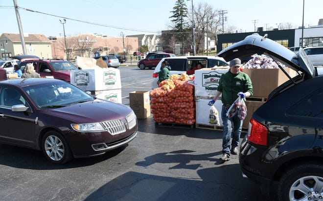Gleaner program manager Jake Williams loads food into a vehicle.